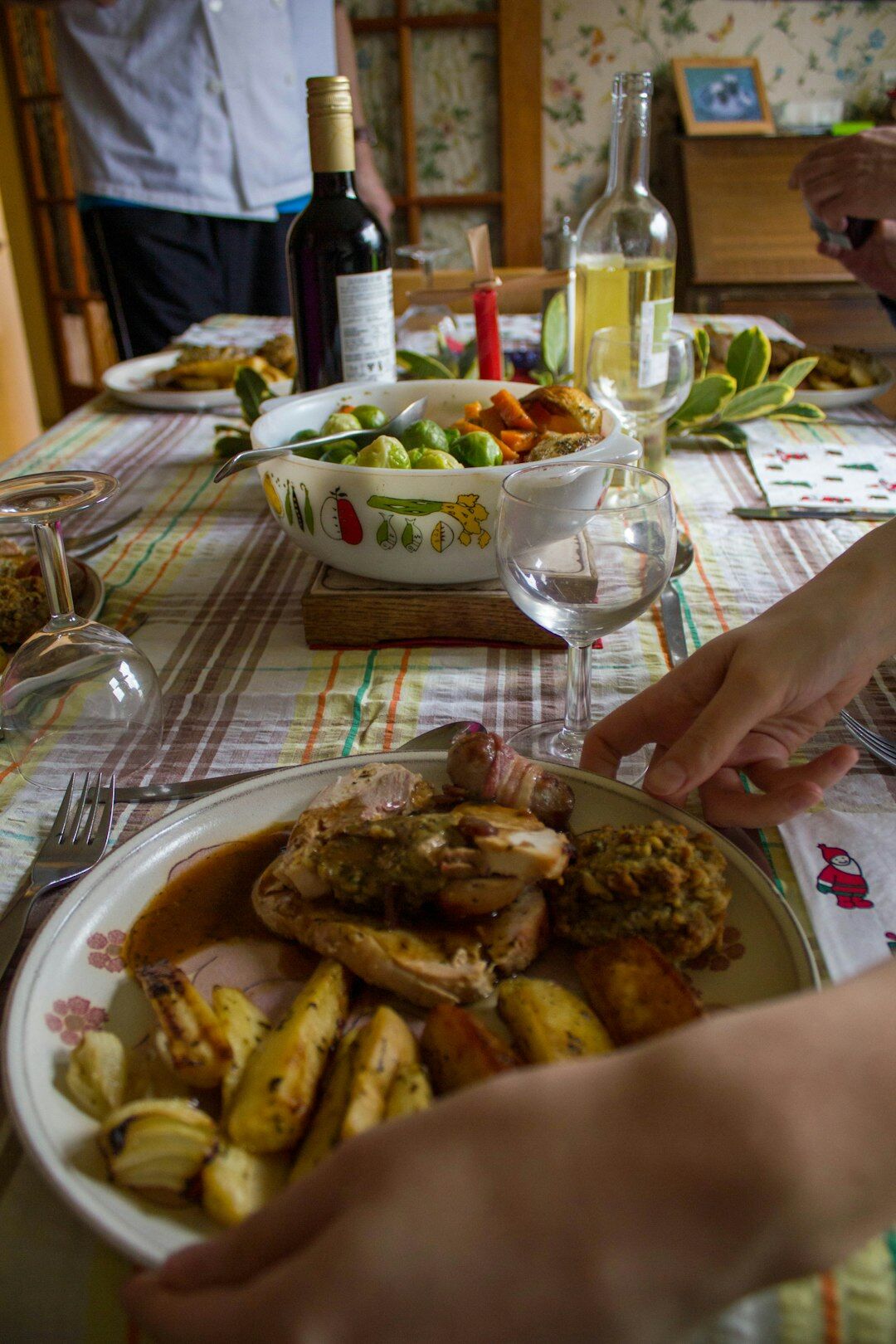Traditional Czech food spread on a wooden table with roast meat, dumplings and gravy